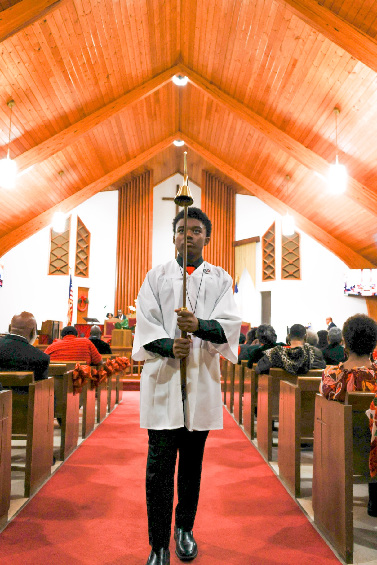 Young crucifer leading worship procession at Hope Chapel